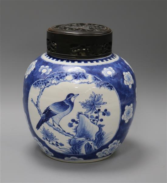 A Chinese blue and white prunus jar, wood cover, 19th century overall height 24cm
